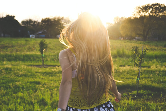 A person running outdoors in the sunlight