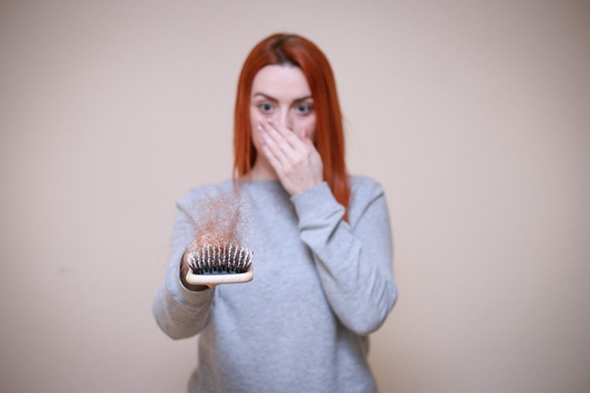 A person facing hair loss due to zinc deficiency