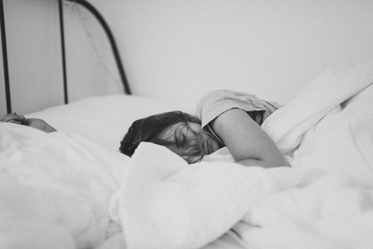 A person sleeping in their bed.