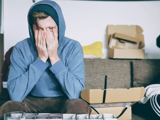 A stressed person sitting in their room