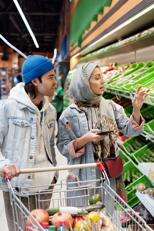 A couple buying fresh vegetables from a supermarket